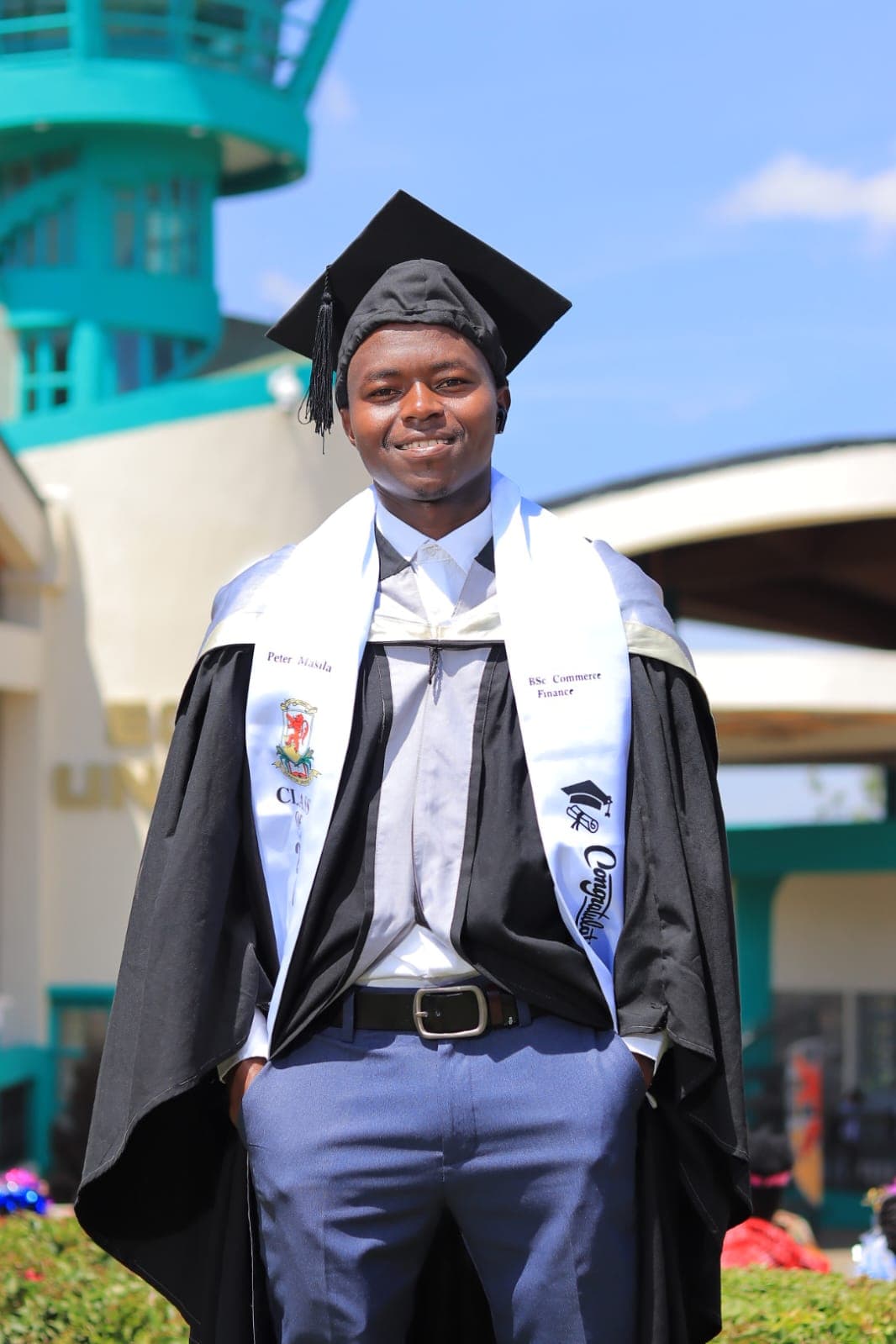 Portrait of Peter Masila, a confident young man smiling